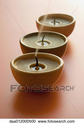 Stock Image - Three extinguished candles. Fotosearch
