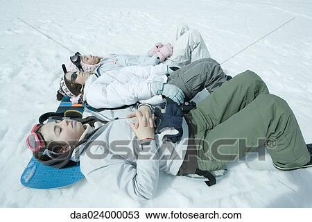 Three sisters lying on snow with heads resting on snowboard View Large Photo Image Stock Image - Three sisters lying on snow with heads resting on snowboard. Fotosearch