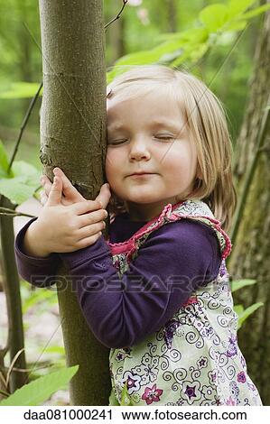 Toddler girl hugging tree with eyes closed View Large Photo Image Stock Image - Toddler girl hugging tree with eyes closed. Fotosearch