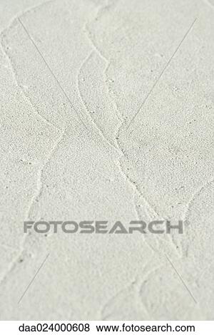 Stock Photo - Traces of surf on sand at low tide, close-up. Fotosearch