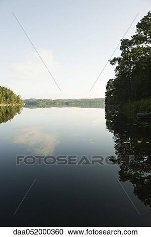 Stock Image - Tranquil lake scene. Fotosearch