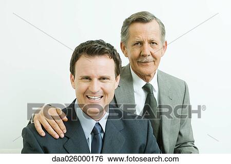 Two businessmen smiling at camera, portrait View Large Photo Image Stock Photograph - Two businessmen smiling at camera, portrait. Fotosearch