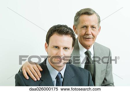 Two businessmen smiling at camera, portrait View Large Photo Image Stock Photography - Two businessmen smiling at camera, portrait. Fotosearch