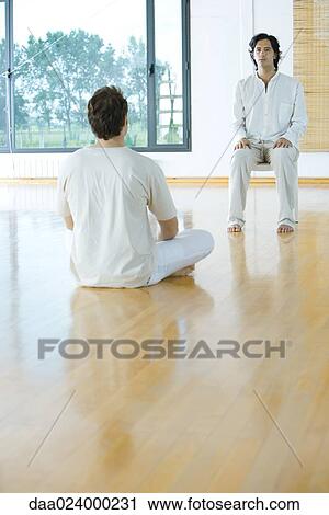 Two men facing each other in alternative therapy session View Large Photo Image Stock Image - Two men facing each other in alternative therapy session. Fotosearch