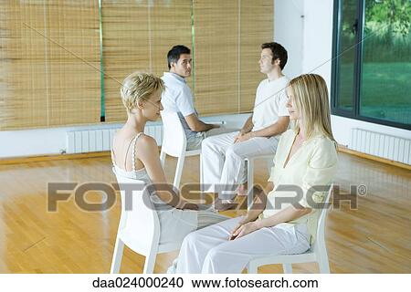 Two pairs of adults sitting together during therapy session View Large Photo Image Stock Image - Two pairs of adults sitting together during therapy session. Fotosearch