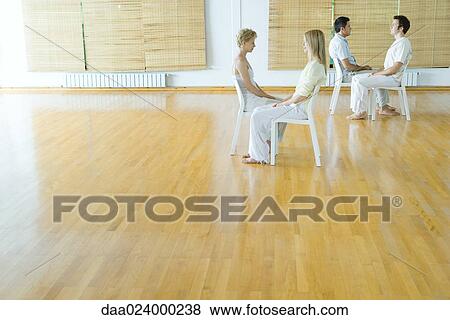 Two pairs of adults sitting together during therapy session View Large Photo Image Stock Photo - Two pairs of adults sitting together during therapy session. Fotosearch