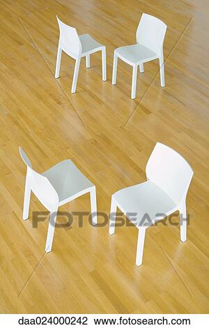 Two pairs of chairs on hardwood floor, high angle view View Large Photo Image Stock Image - Two pairs of chairs on hardwood floor, high angle view. Fotosearch