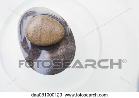 Stock Photo - Two stacked stones partially submerged in water. Fotosearch