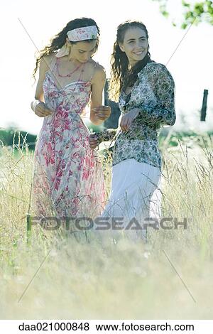 Stock Photo - Two young women standing in field. Fotosearch