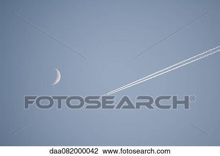 Vapor trail and crescent moon in sky View Large Photo Image Stock Image - Vapor trail and crescent moon in sky. Fotosearch