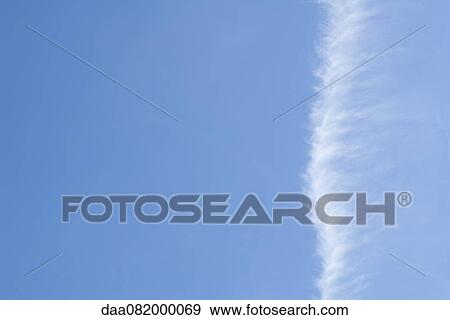 Vapor trail in blue sky View Large Photo Image Stock Photo - Vapor trail in blue sky. Fotosearch