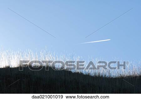 Vapor trail in sky View Large Photo Image Stock Photo - Vapor trail in sky. Fotosearch