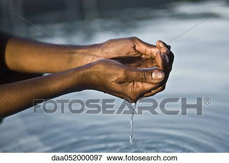 Water flowing from cupped hands View Large Photo Image Stock Photo - Water flowing from cupped hands. Fotosearch