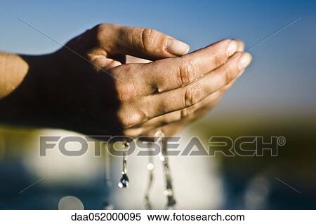 Water flowing from cupped hands View Large Photo Image Stock Photography - Water flowing from cupped hands. Fotosearch
