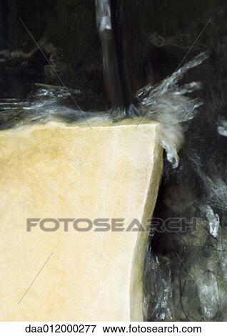 Stock Photo - Water flowing onto stone surface. Fotosearch