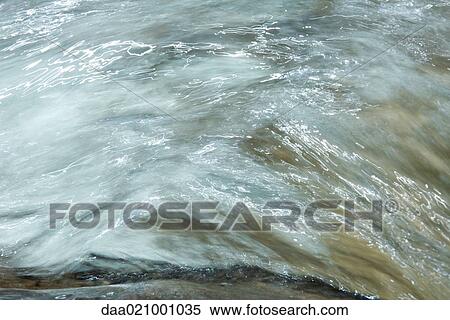 Stock Photography - Water running, abstract view, full frame. Fotosearch