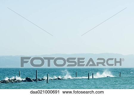 Waves hitting breakwater View Large Photo Image Stock Image - Waves hitting breakwater. Fotosearch