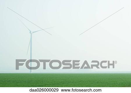 Wind turbine in foggy landscape View Large Photo Image Stock Photo - Wind turbine in foggy landscape. Fotosearch