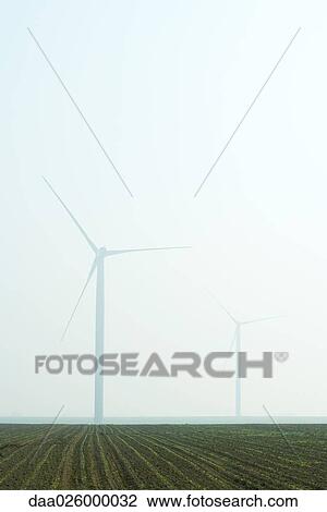 Wind turbines in foggy landscape View Large Photo Image Stock Image - Wind turbines in foggy landscape. Fotosearch