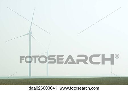 Wind turbines in foggy landscape View Large Photo Image Stock Image - Wind turbines in foggy landscape. Fotosearch