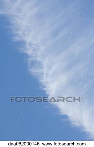Stock Photograph - Wispy cloud in blue sky. Fotosearch