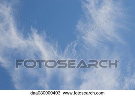 Stock Image - Wispy clouds in blue sky. Fotosearch