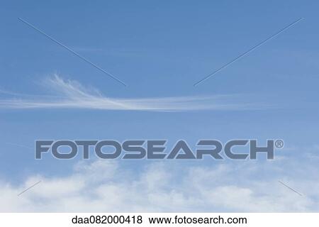 Wispy clouds in blue sky View Large Photo Image Stock Photo - Wispy clouds in blue sky. Fotosearch