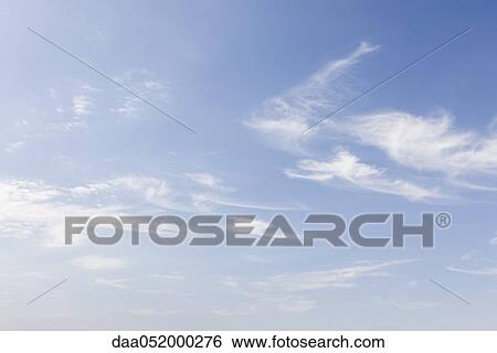 Wispy clouds in blue sky View Large Photo Image Stock Photograph - Wispy clouds in blue sky. Fotosearch