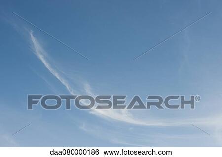 Stock Photograph - Wispy clouds in blue sky. Fotosearch