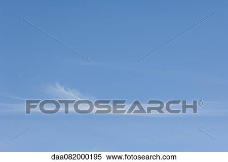 Stock Photography - Wispy clouds in blue sky. Fotosearch