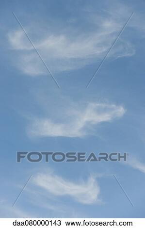 Stock Image - Wispy clouds in sky. Fotosearch