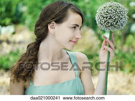 Stock Image - Woman and allium flower. Fotosearch