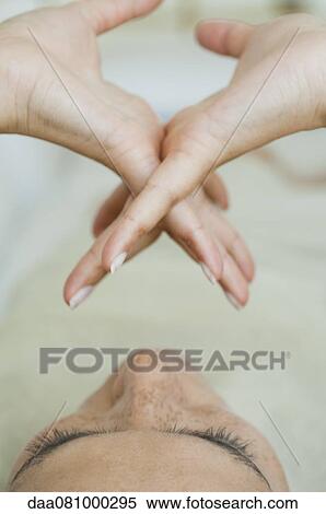 Stock Photography - Woman contemplating clasped hands. Fotosearch