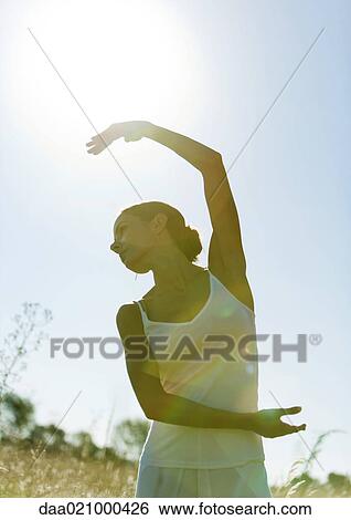 Woman dancing in field View Large Photo Image Stock Photograph - Woman dancing in field. Fotosearch