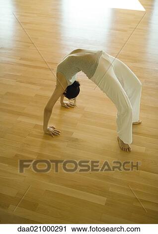 Woman doing bridge position, high angle view View Large Photo Image Stock Image - Woman doing bridge position, high angle view. Fotosearch