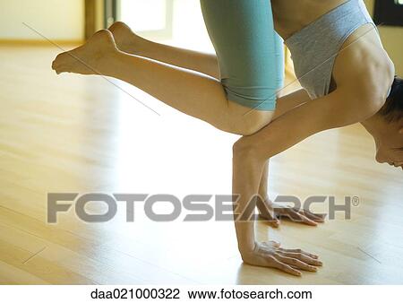 Woman doing crow pose View Large Photo Image Stock Image - Woman doing crow pose. Fotosearch