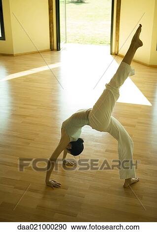 Woman doing one-legged bridge pose View Large Photo Image Stock Image - Woman doing one-legged bridge pose. Fotosearch