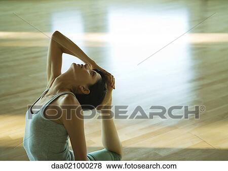 Woman doing one-legged king pigeon pose View Large Photo Image Stock Photo - Woman doing one-legged king pigeon pose. Fotosearch