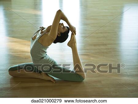 Woman doing one-legged king pigeon pose View Large Photo Image Stock Photo - Woman doing one-legged king pigeon pose. Fotosearch