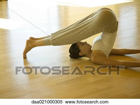 Woman doing plow pose View Large Photo Image Stock Photography - Woman doing plow pose. Fotosearch