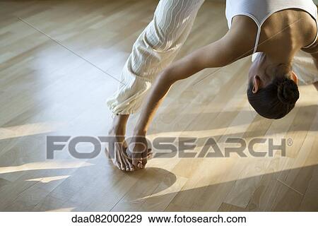 Woman doing prasarita padottanasana yoga pose, cropped View Large Photo Image Stock Photo - Woman doing prasarita padottanasana yoga pose, cropped. Fotosearch