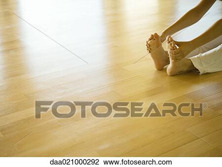 Woman doing seated forward bend, cropped view of hands and feet View Large Photo Image Stock Image - Woman doing seated forward bend, cropped view of hands and feet. Fotosearch