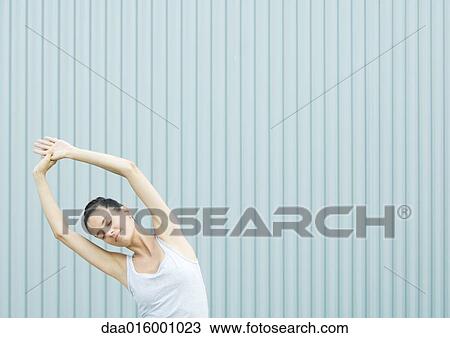 Woman doing side stretch View Large Photo Image Stock Image - Woman doing side stretch. Fotosearch