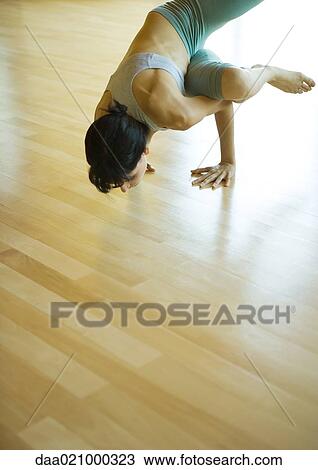 Woman doing sideways crow pose View Large Photo Image Stock Image - Woman doing sideways crow pose. Fotosearch