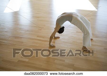 Woman doing wheel pose (Urdhva Dhanurasana) View Large Photo Image Stock Image - Woman doing wheel pose (Urdhva Dhanurasana). Fotosearch