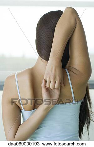 Woman doing yoga cow face pose, rear view View Large Photo Image Stock Image - Woman doing yoga cow face pose, rear view. Fotosearch