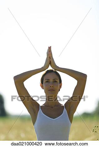Woman doing yoga pose in field View Large Photo Image Stock Image - Woman doing yoga pose in field. Fotosearch