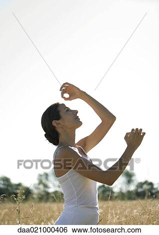 Woman doing yoga pose in field View Large Photo Image Stock Photograph - Woman doing yoga pose in field. Fotosearch