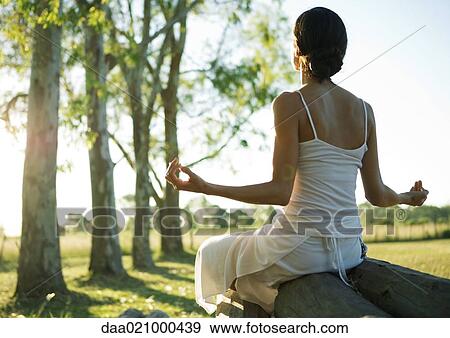Stock Photo - Woman doing yoga pose outdoors. Fotosearch