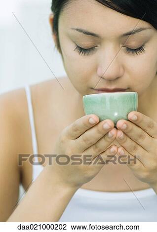 Woman drinking from tea cup, eyes closed View Large Photo Image Stock Image - Woman drinking from tea cup, eyes closed. Fotosearch